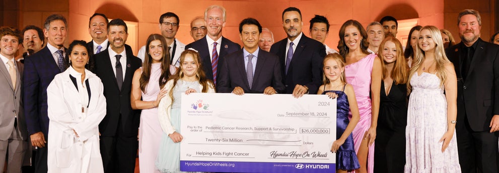 helping kids fight cancer foundation showing their big check from hyundai hope on wheels - Hyundai of Bowie in Bowie MD