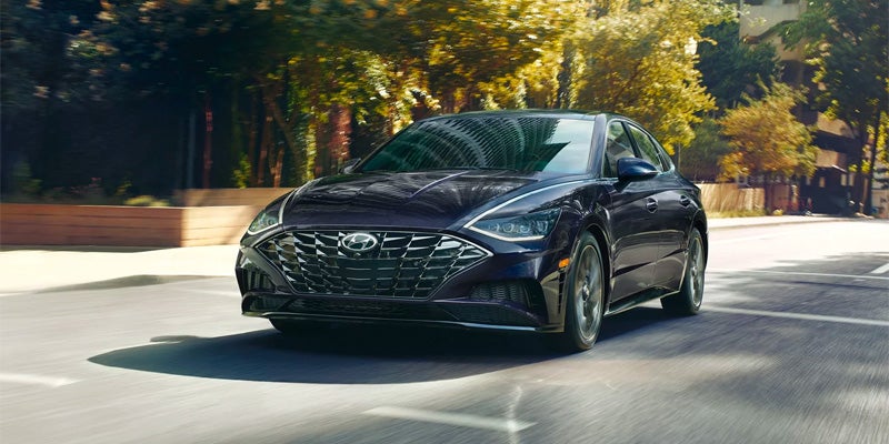 Hyundai Sonata N Line sedan driving through city street