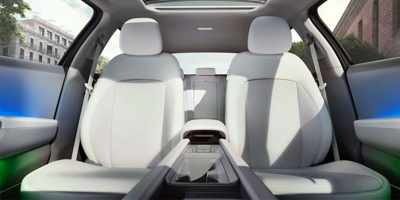 Premium electric vehicle front interior with white seats