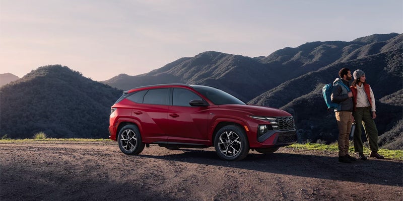 Hyundai Tucson SUV side profile with mountain backdrop